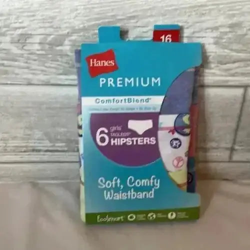 Front view of Hanes girls ComfortBlend 6-pack hipsters size 16 showing Premium label and Soft Comfy Waistband on wood
