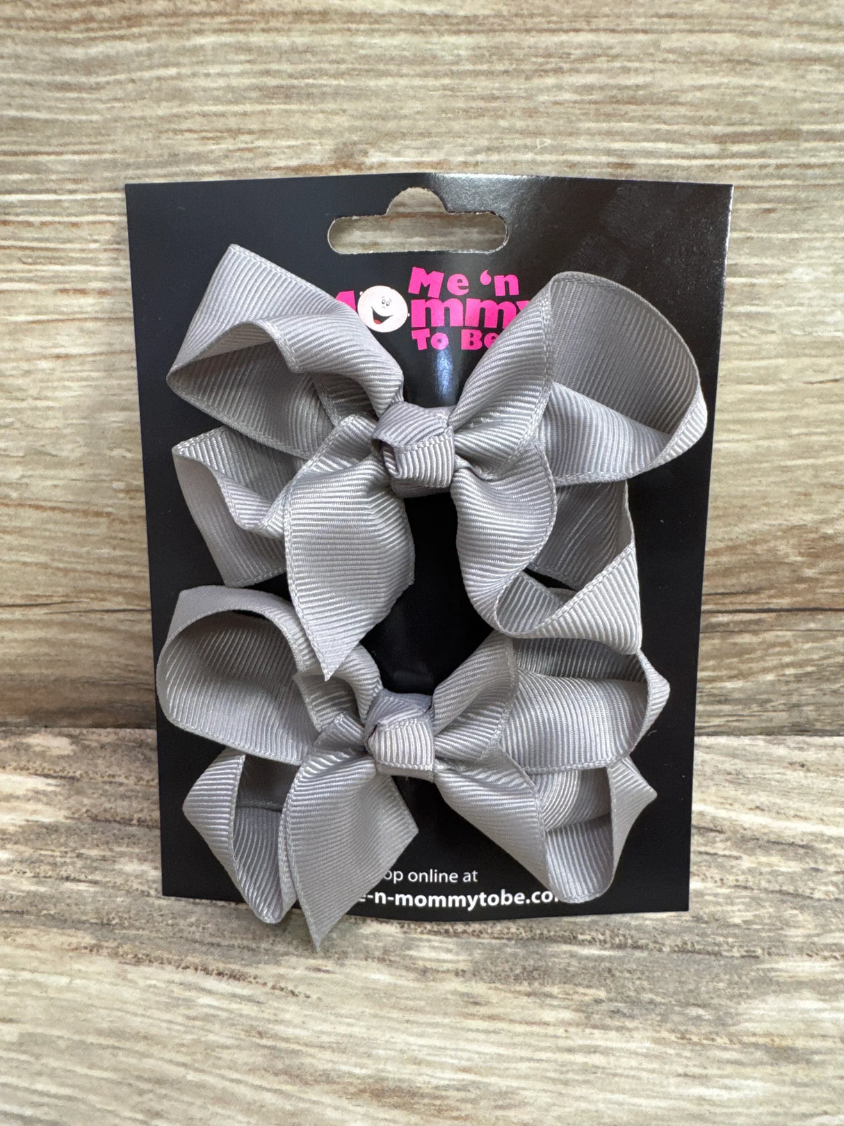 Front view of two medium grey hair bows (2-pack) showing tied bow shape and alligator clips on white background