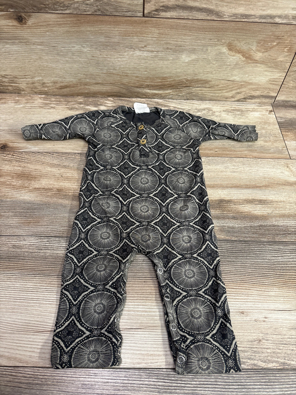 Front view of The Woods by Kate Quinn Beechwood modal coverall in grey with a circular geometric pattern and front snaps