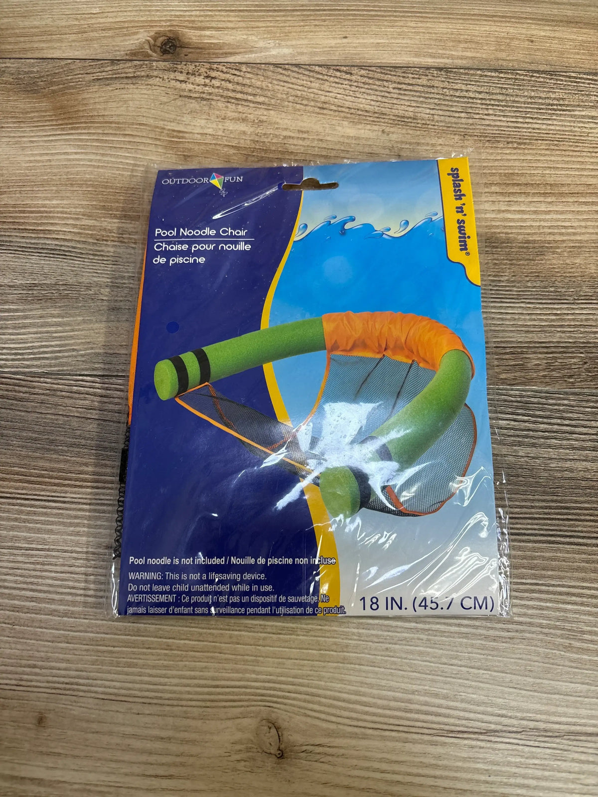 Top-down of pool noodle chair showing green noodle and orange mesh seat, label Pool Noodle Chair and 18 in on wood surface