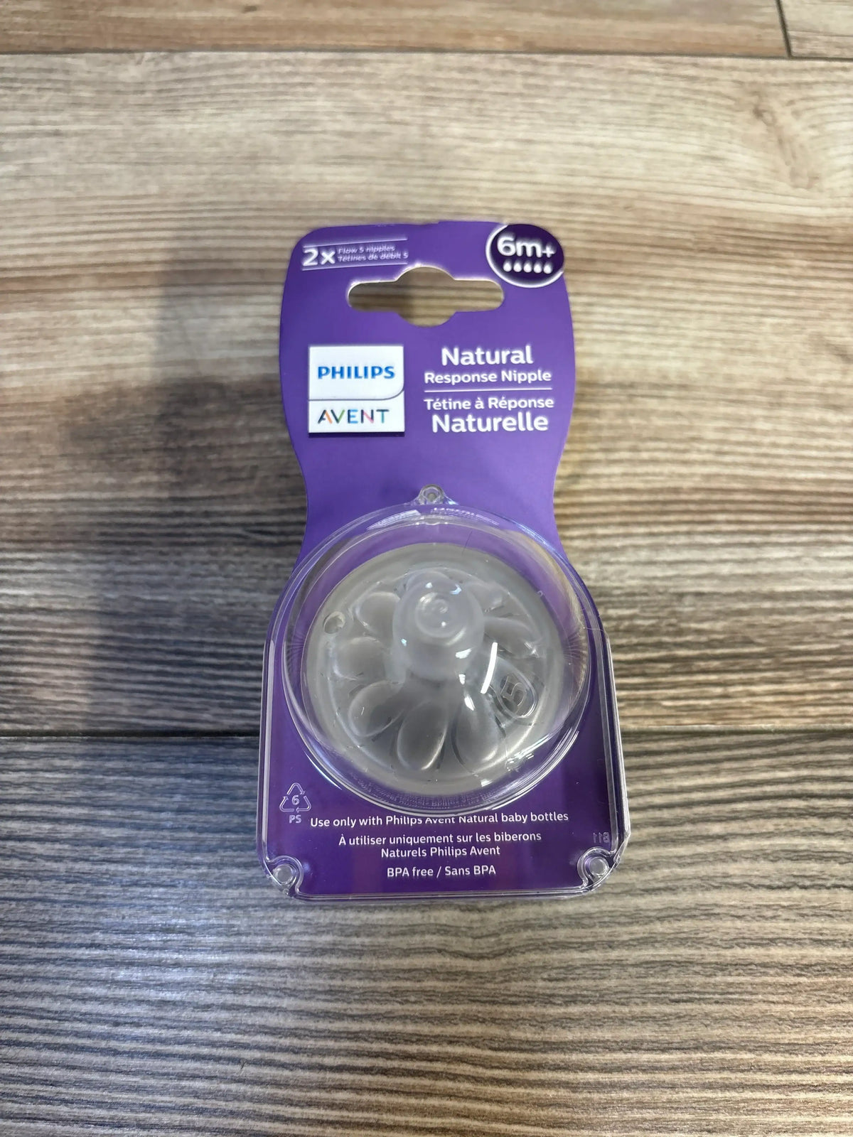 Philips Avent Natural Response Nipple pack for baby bottles on wood background, size 6m+