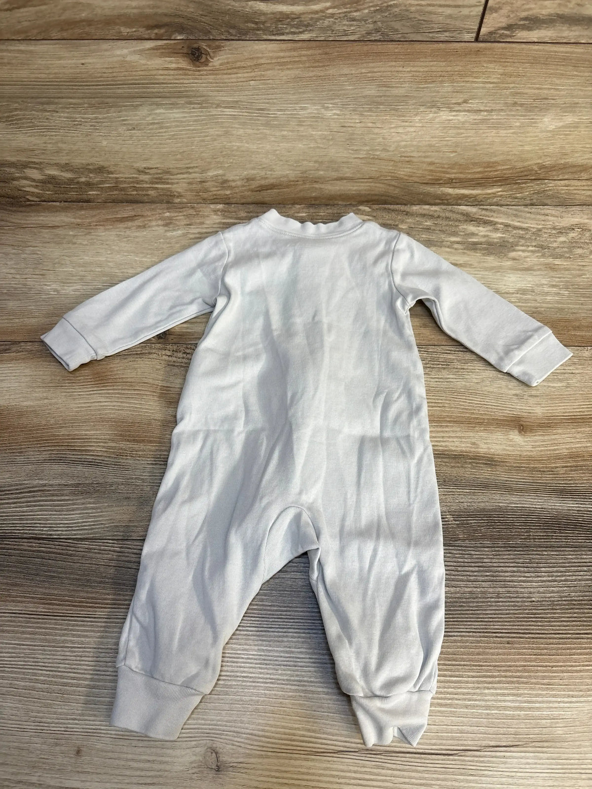 Back view of Amazon Essentials sleeper in light grey showcasing long sleeves and cuffed ankles on wood plank floor