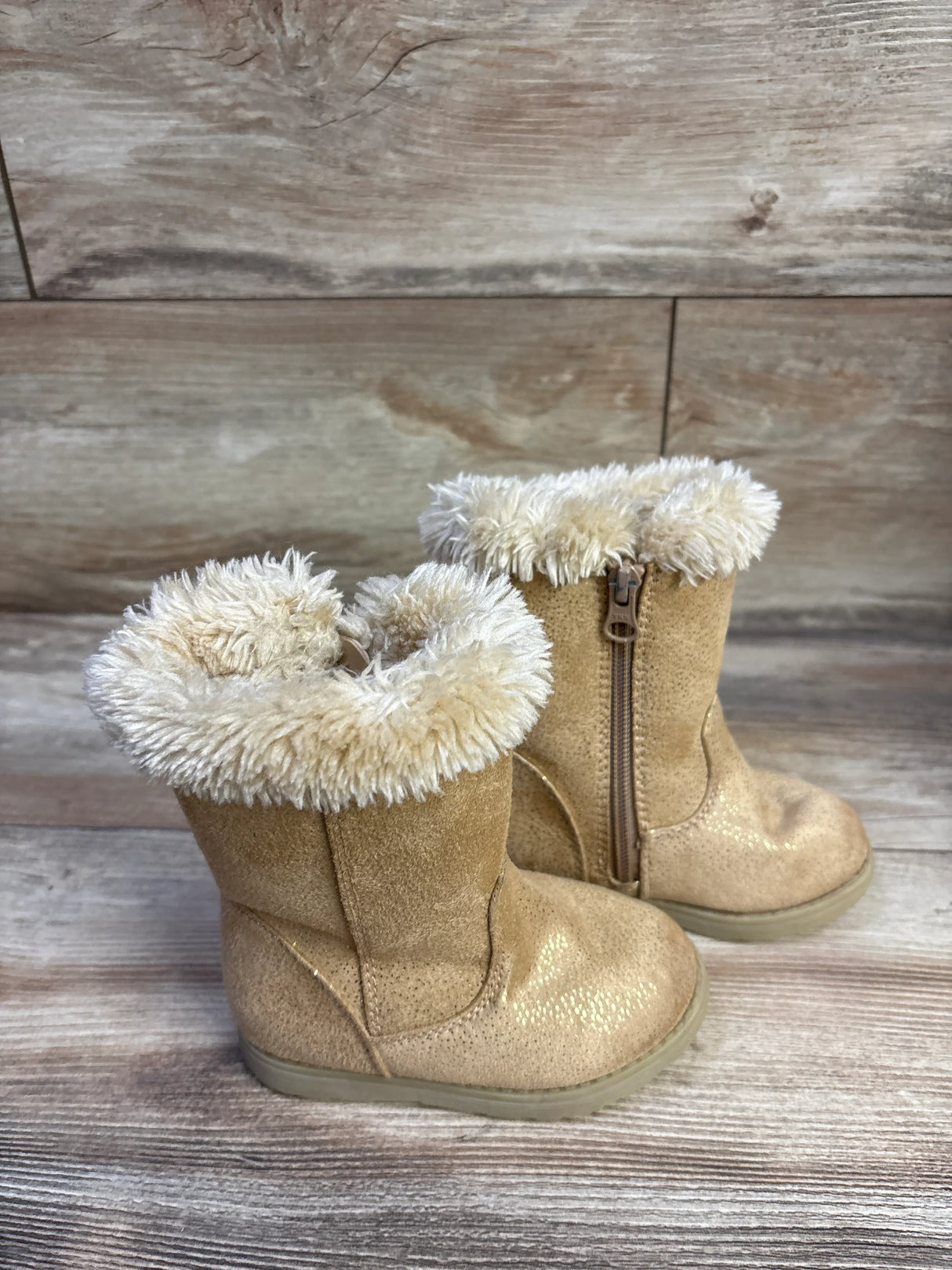 Three-quarter view of Cat and Jack toddler winter boots in cognac showing faux-fur cuff and side zipper on wood background