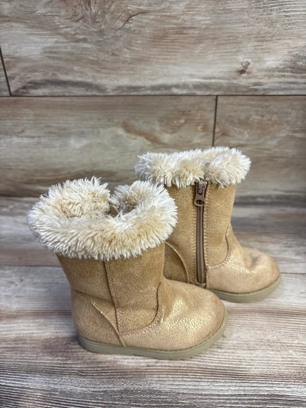 Three-quarter view of Cat and Jack toddler winter boots in cognac showing faux-fur cuff and side zipper on wood background