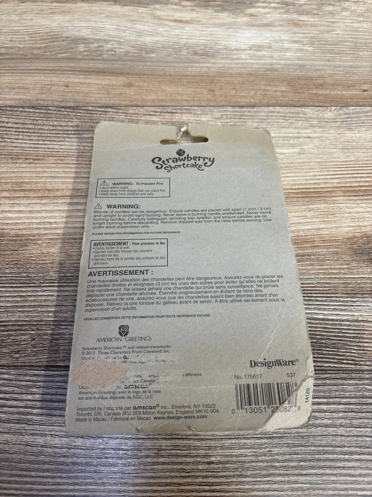 Strawberry Shortcake vintage packaging with safety warnings on a wooden surface