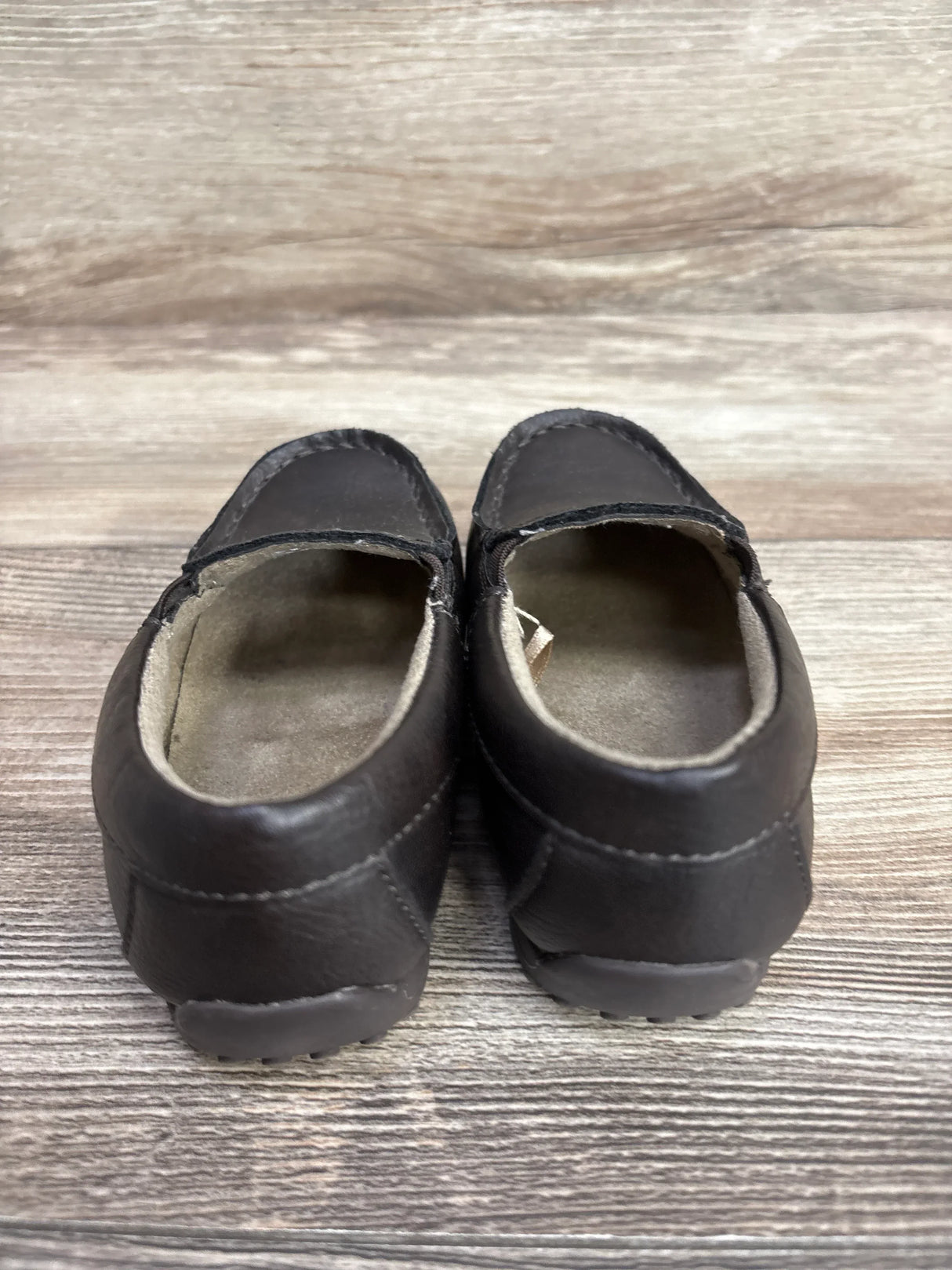 Back view of Children's Place brown slip-on dress shoes size 8C showcasing loafer heel and light wear on wood floor