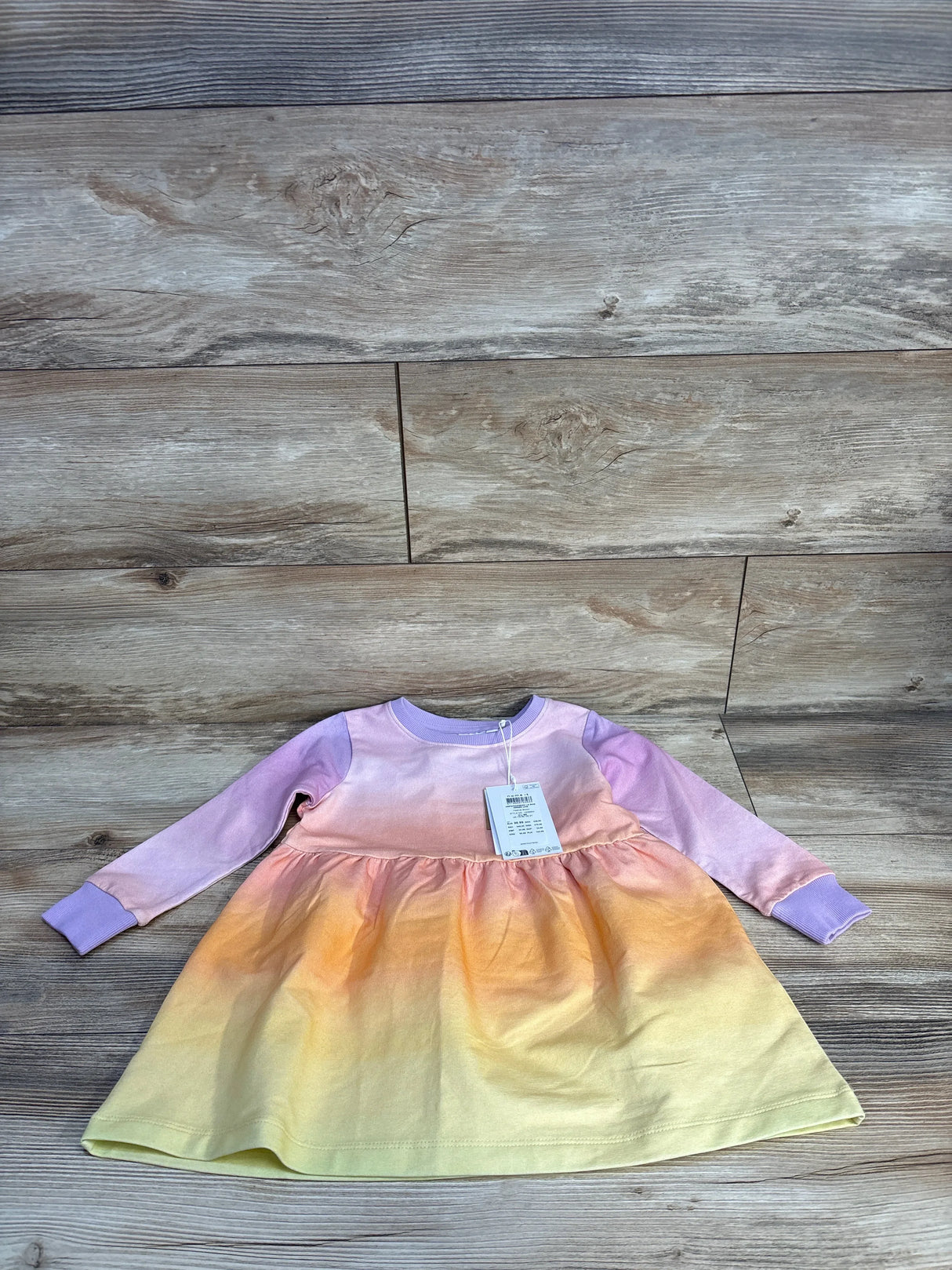 Pastel rainbow ombre baby dress with long sleeves, perfect for kids clothing resale