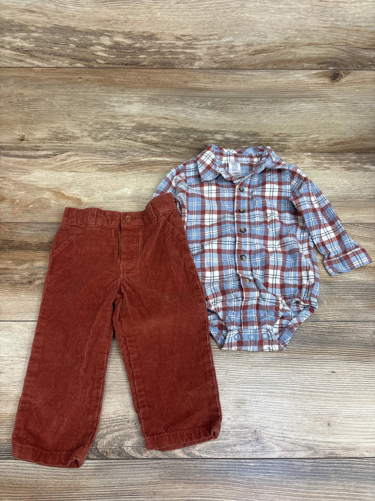 Top-down view of Just One You 2-piece outfit showcasing a blue plaid bodysuit and brown corduroy pants on wood