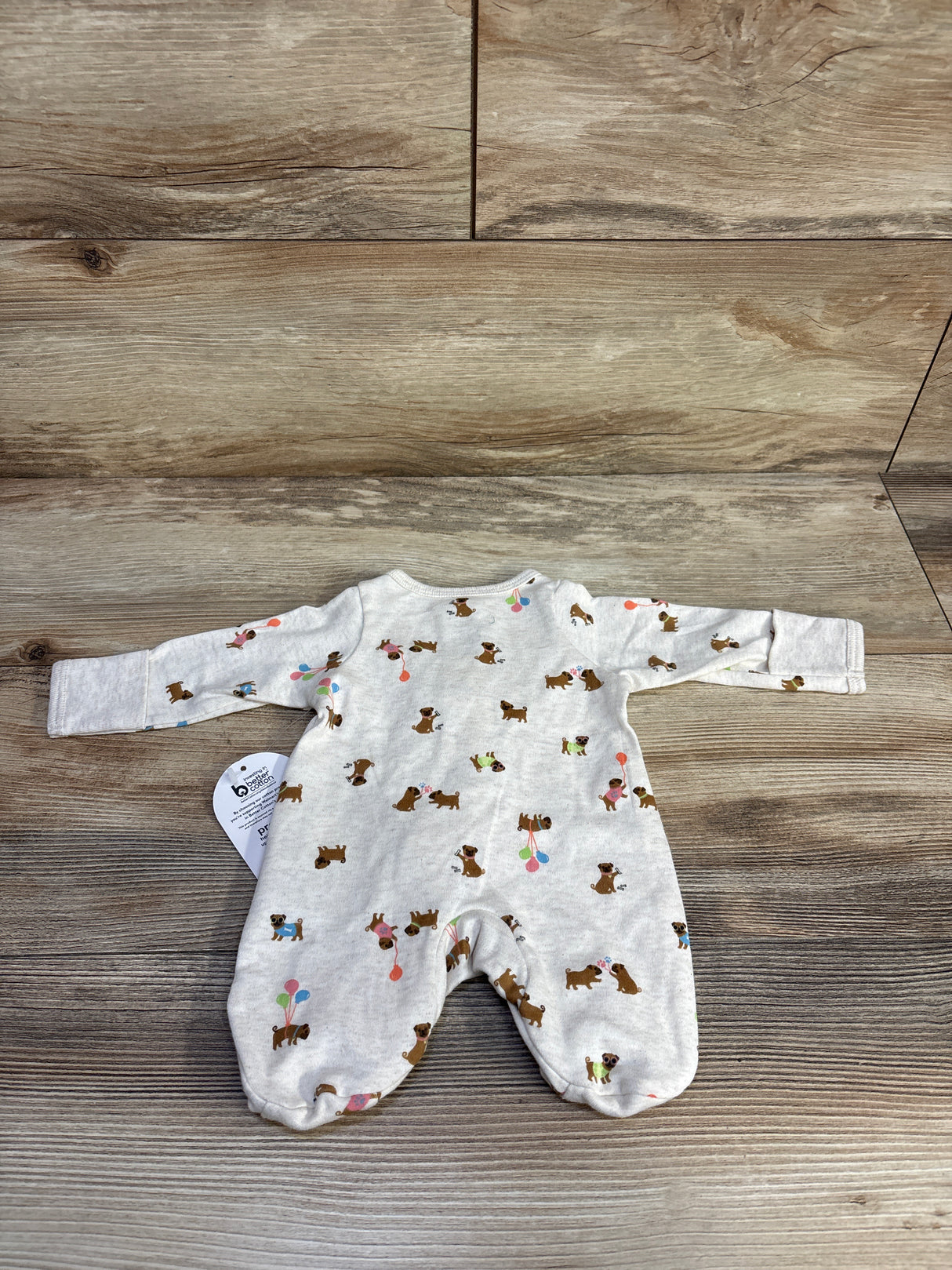 Cute dog print baby romper with balloons on wood background, long sleeve infant pajamas