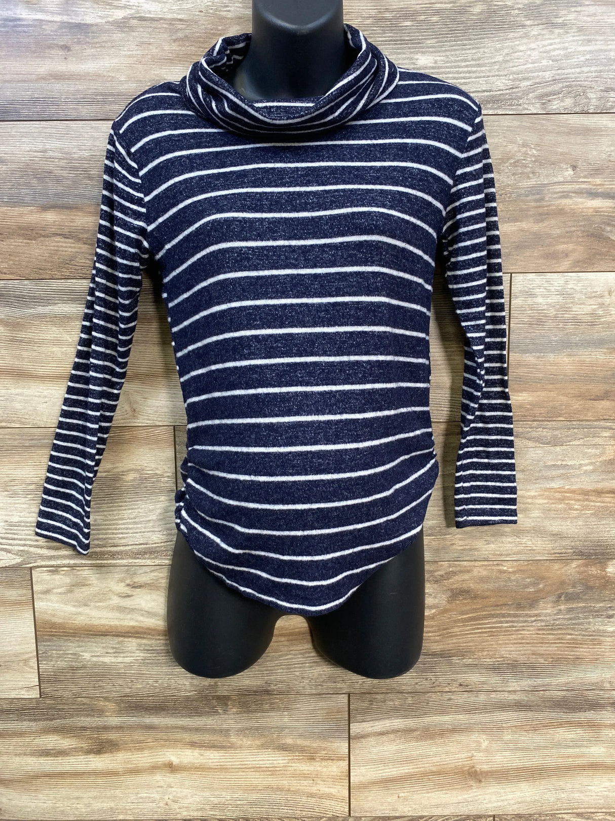 Navy blue and white striped cowl neck long sleeve shirt on mannequin, wood background