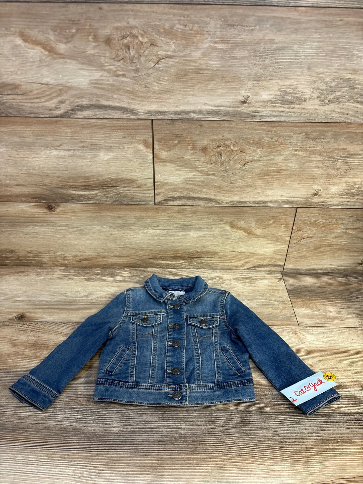 Cat & Jack toddler blue denim jacket with button front on wood background