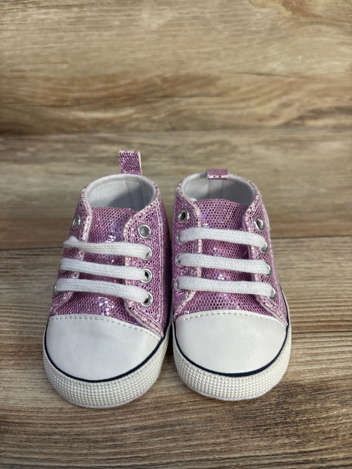 Pair of Me n Mommy To Be purple glittery slip-on crib shoes with white laces and soles.