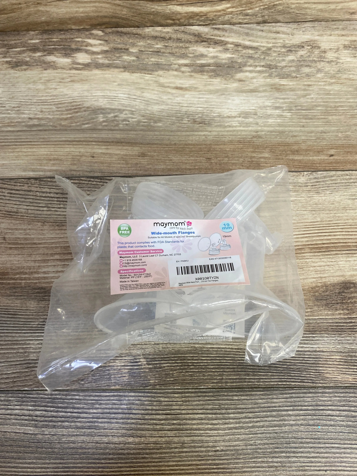 Top-down view of Maymom wide-mouth breast pump flanges 2-pack 19mm in sealed clear bag on wood surface