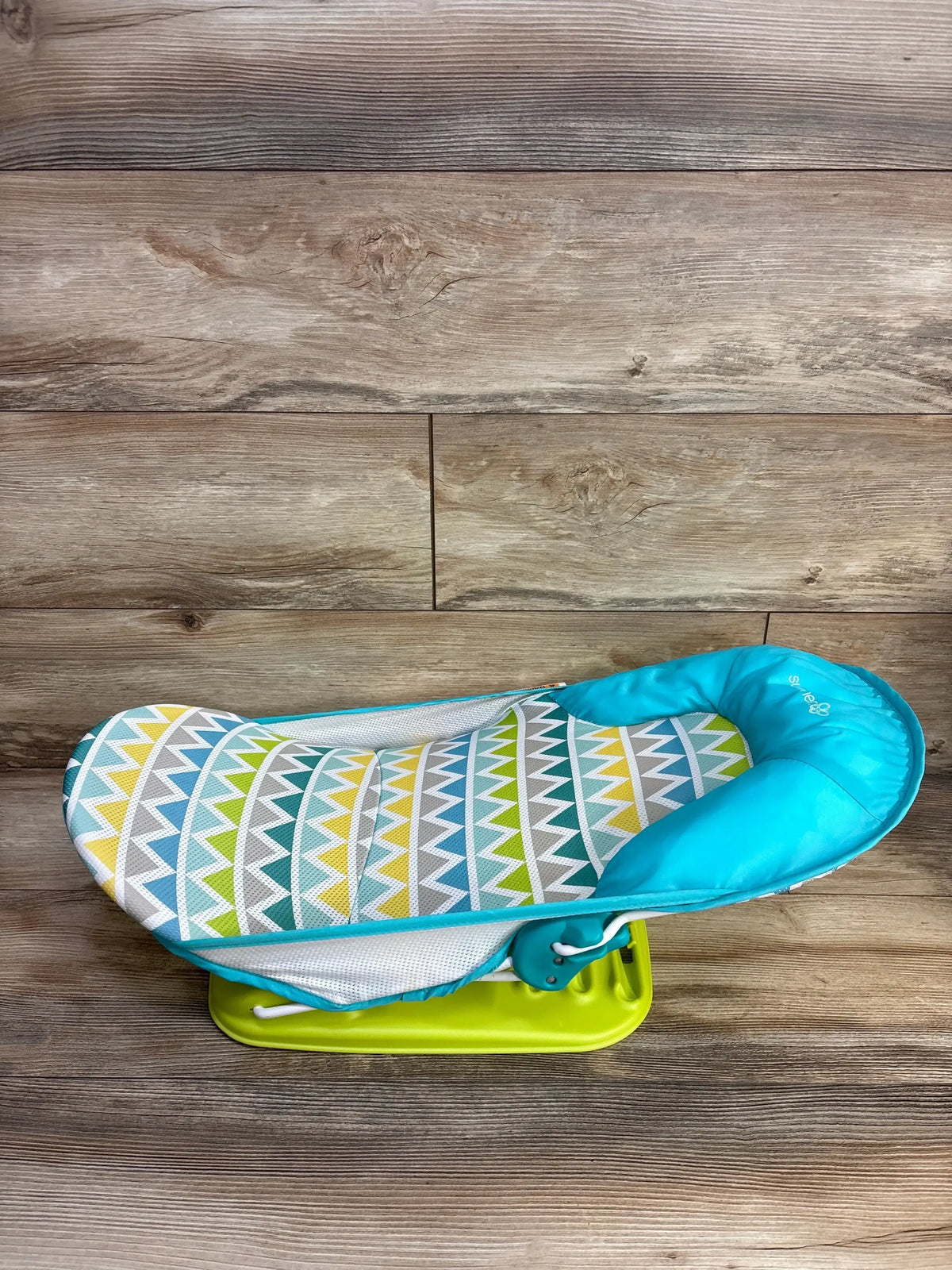 Front view of Summer Deluxe Baby Bather in green showing contoured padded headrest and mesh seat on plain white background