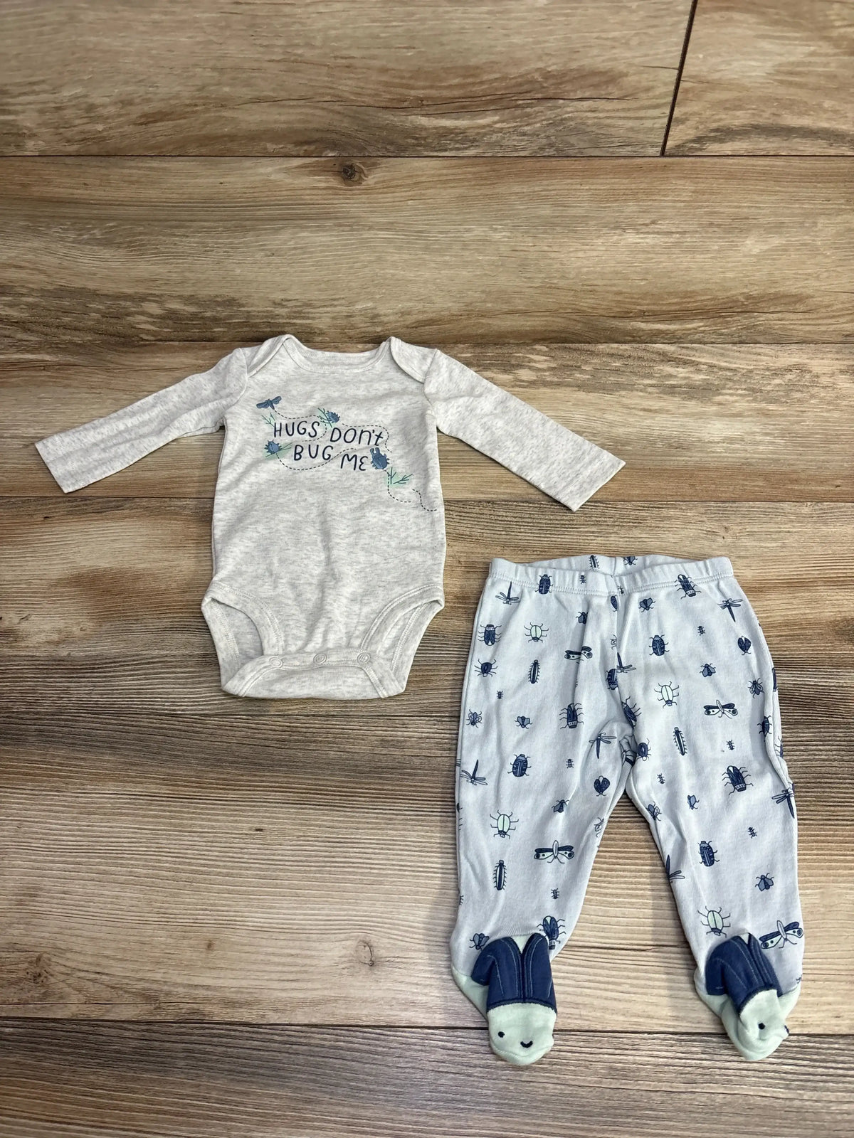 Gray baby bodysuit with 'Hugs Don't Bug Me' text and matching bug print footed pants