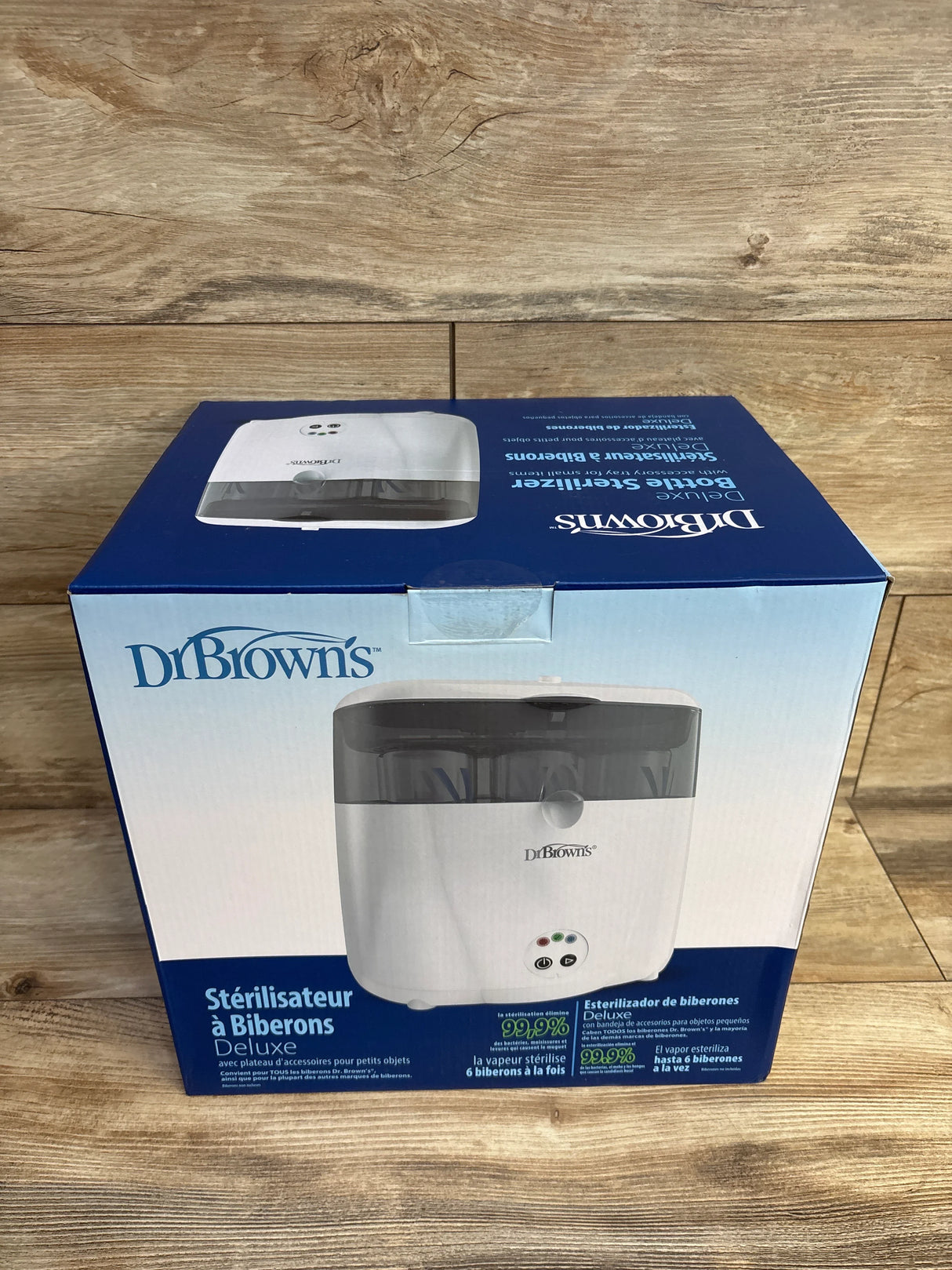 Dr. Brown's deluxe bottle sterilizer box on wood background, product packaging front view
