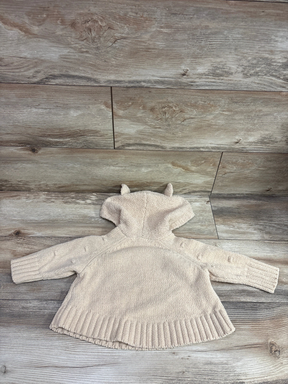 Tan Cat & Jack hooded dot sweater for baby size 12-18m on a wood background