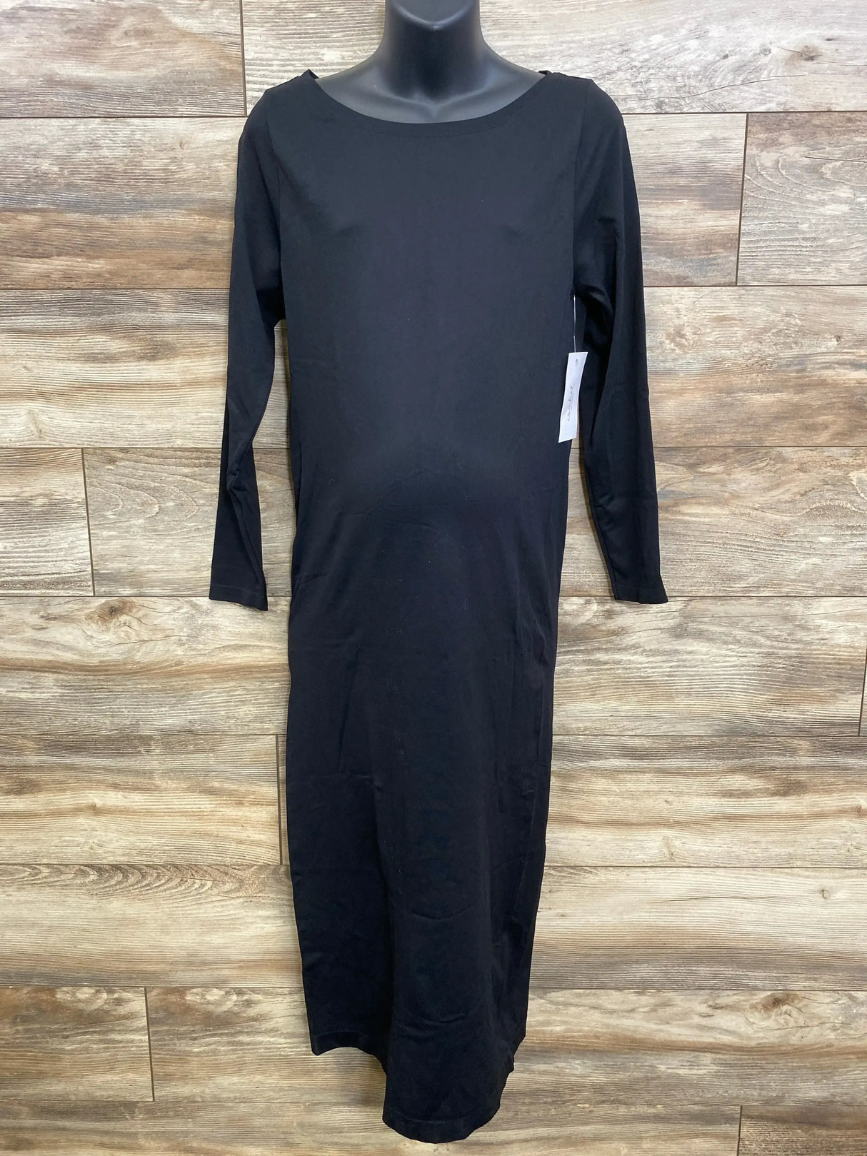 Front view of black maternity long-sleeve dress on mannequin with scoop neck and fitted bump-friendly shape