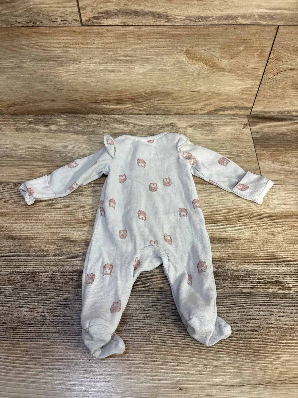 Front view of Child Of Mine owl sleeper in blue, size Preemie, with covered feet and owl print on a wood floor