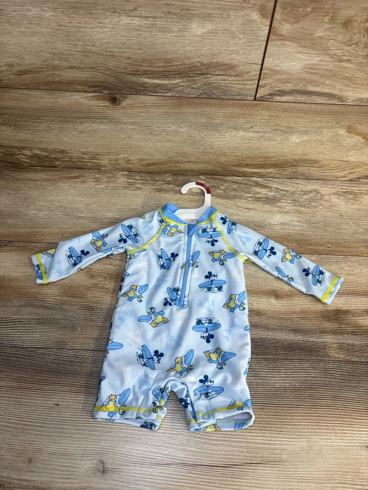 Baby boys' long-sleeve rash guard swim suit with Mickey & Donald surfboard print, size 6M, on hanger