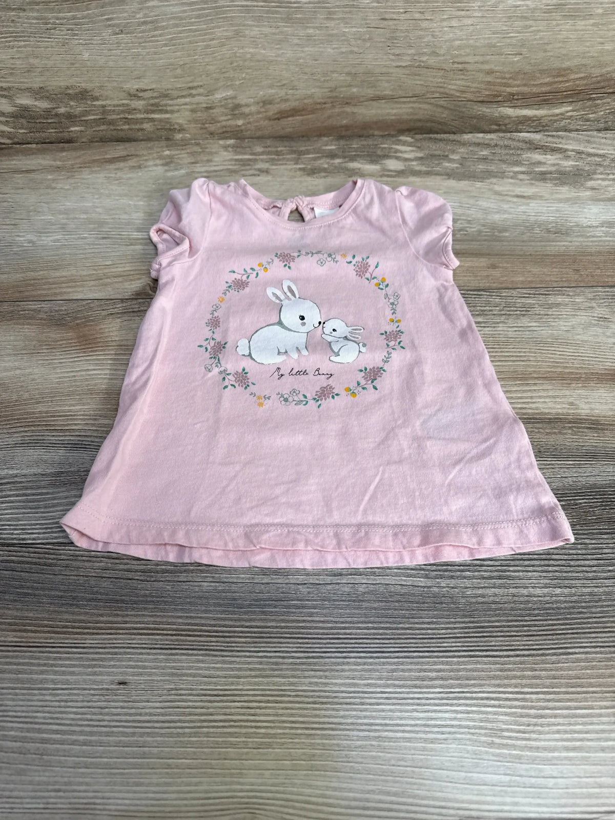 Front view of H&M My Little Bunny pink baby shirt (size 6 months) showing bunny graphic, short sleeves, and snap shoulder on white background