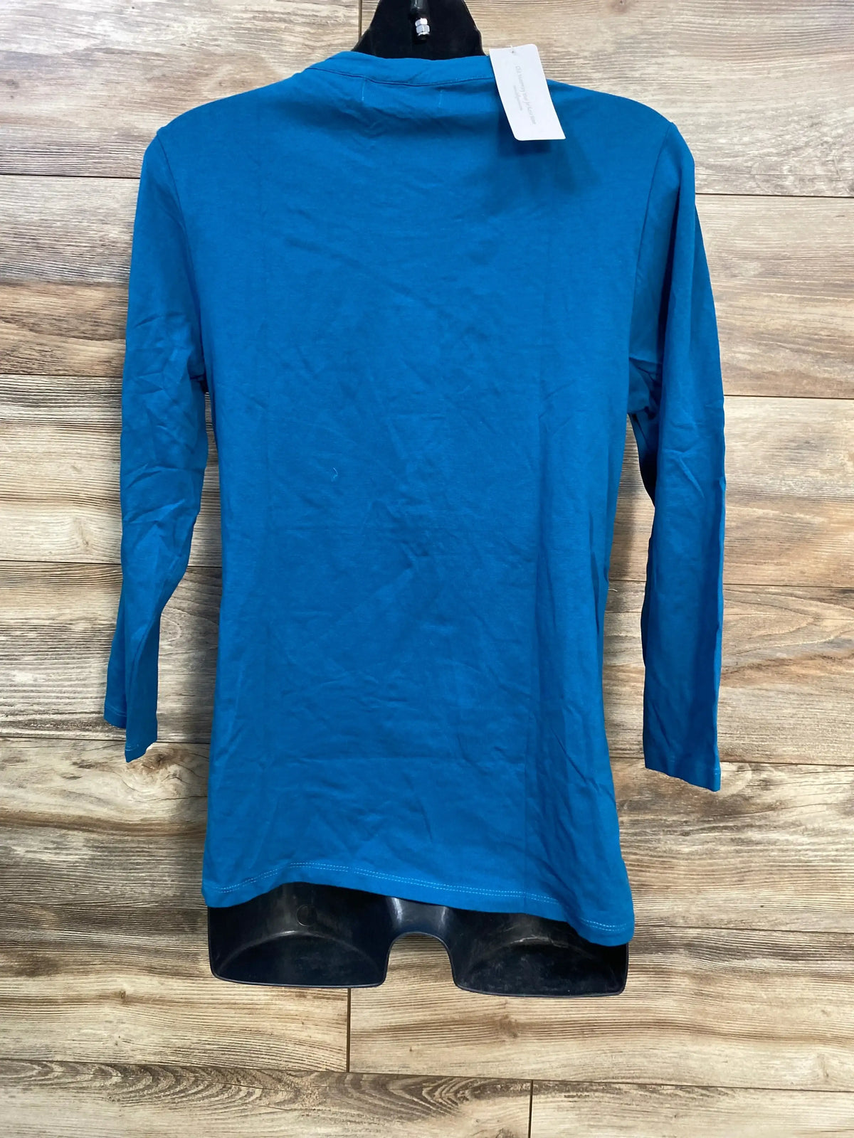 Back view of blue maternity nursing Henley shirt on mannequin showing long sleeves and tunic length against wood background