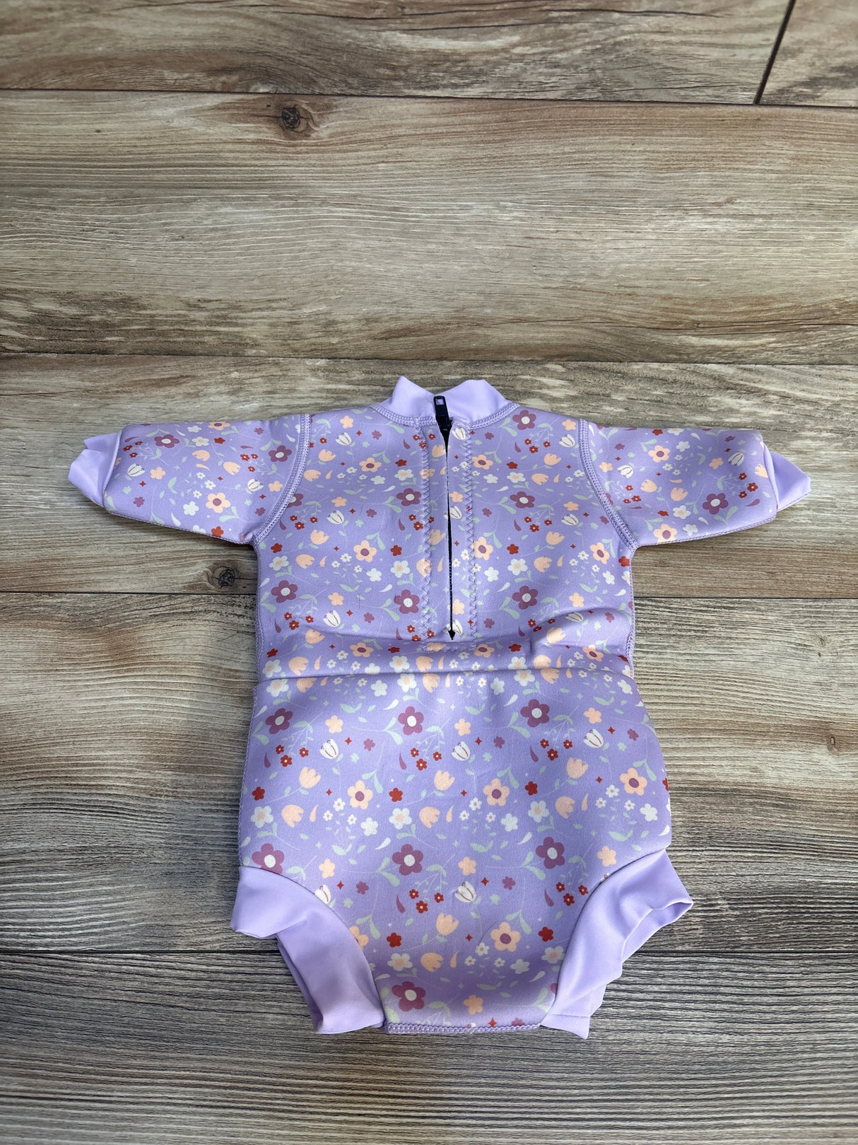 Lavender floral baby rash guard with long sleeves and front zipper, perfect for sun protection and swim time.
