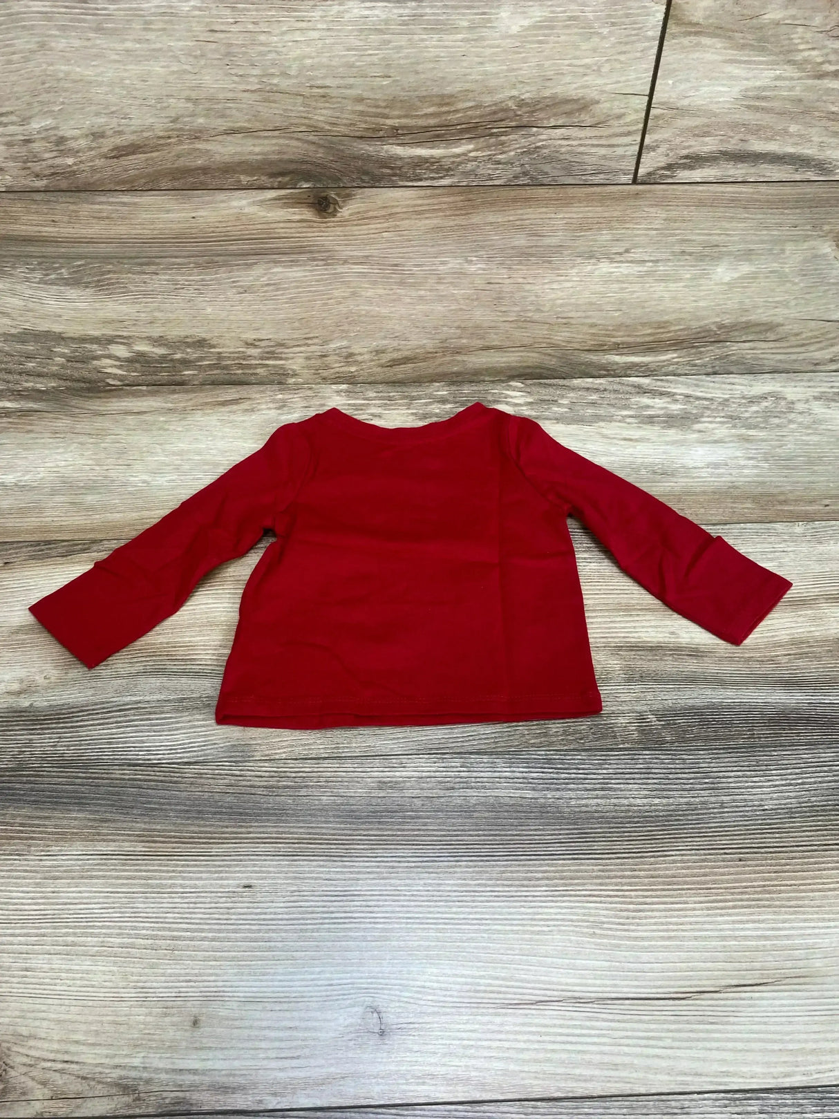 Back view of Cat and Jack Bring The Joy Shirt showcasing solid red long sleeve top on wood plank floor