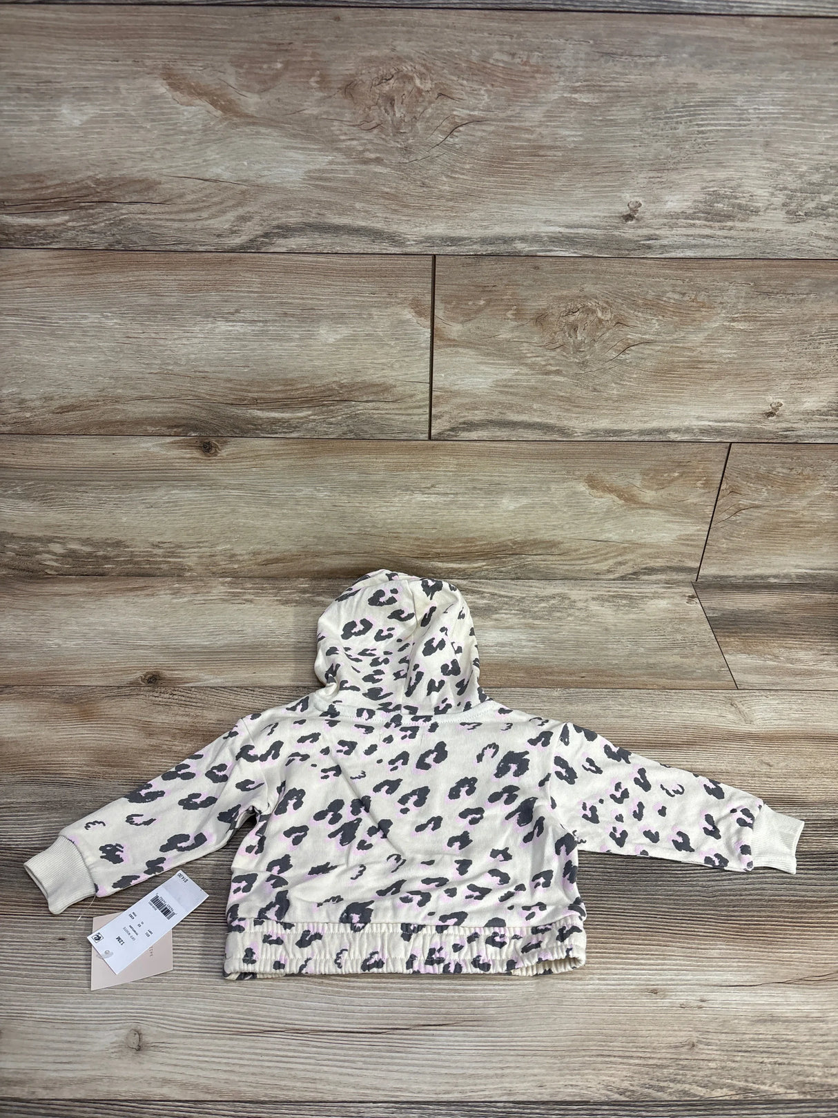 Leopard print toddler hoodie with hood, laid flat on wood background, resale kids clothing