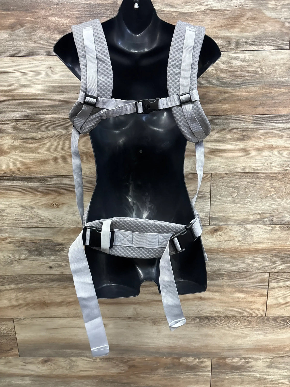 Front view of grey Beyoik all-position baby carrier showcasing padded straps and adjustable buckles on a black mannequin