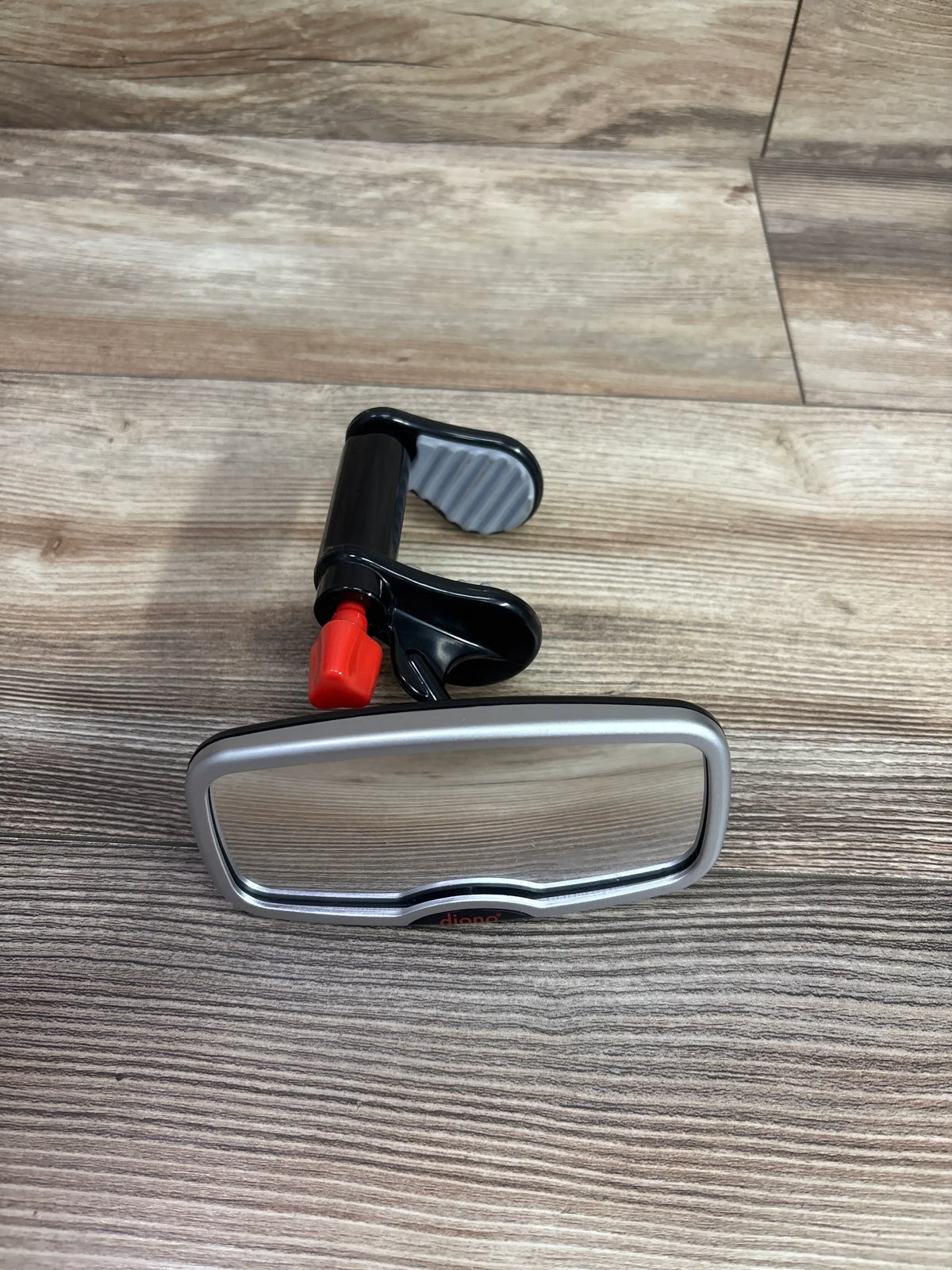 Front view of Diono See Me Too rear view baby mirror showcasing silver frame and black mounting clamp on a wood surface