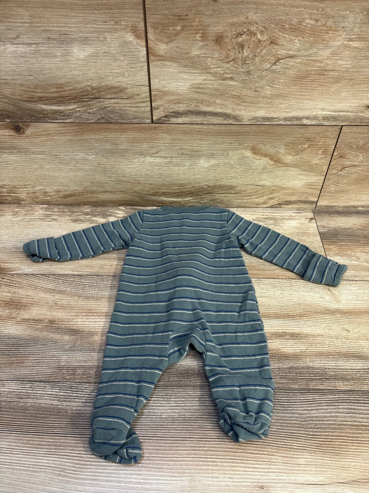 Just One You striped green baby sleeper in size 3m on a wood background