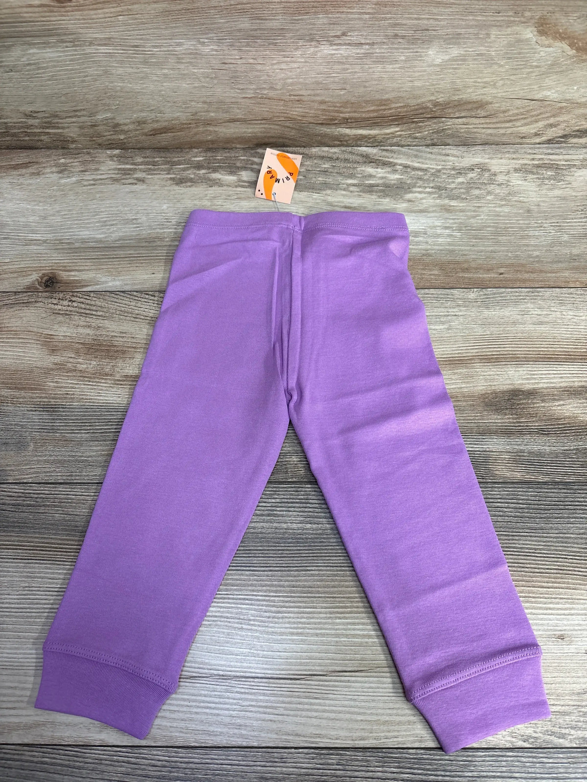 Lilac purple toddler leggings with cuffs laid flat on wood surface, kids resale clothing