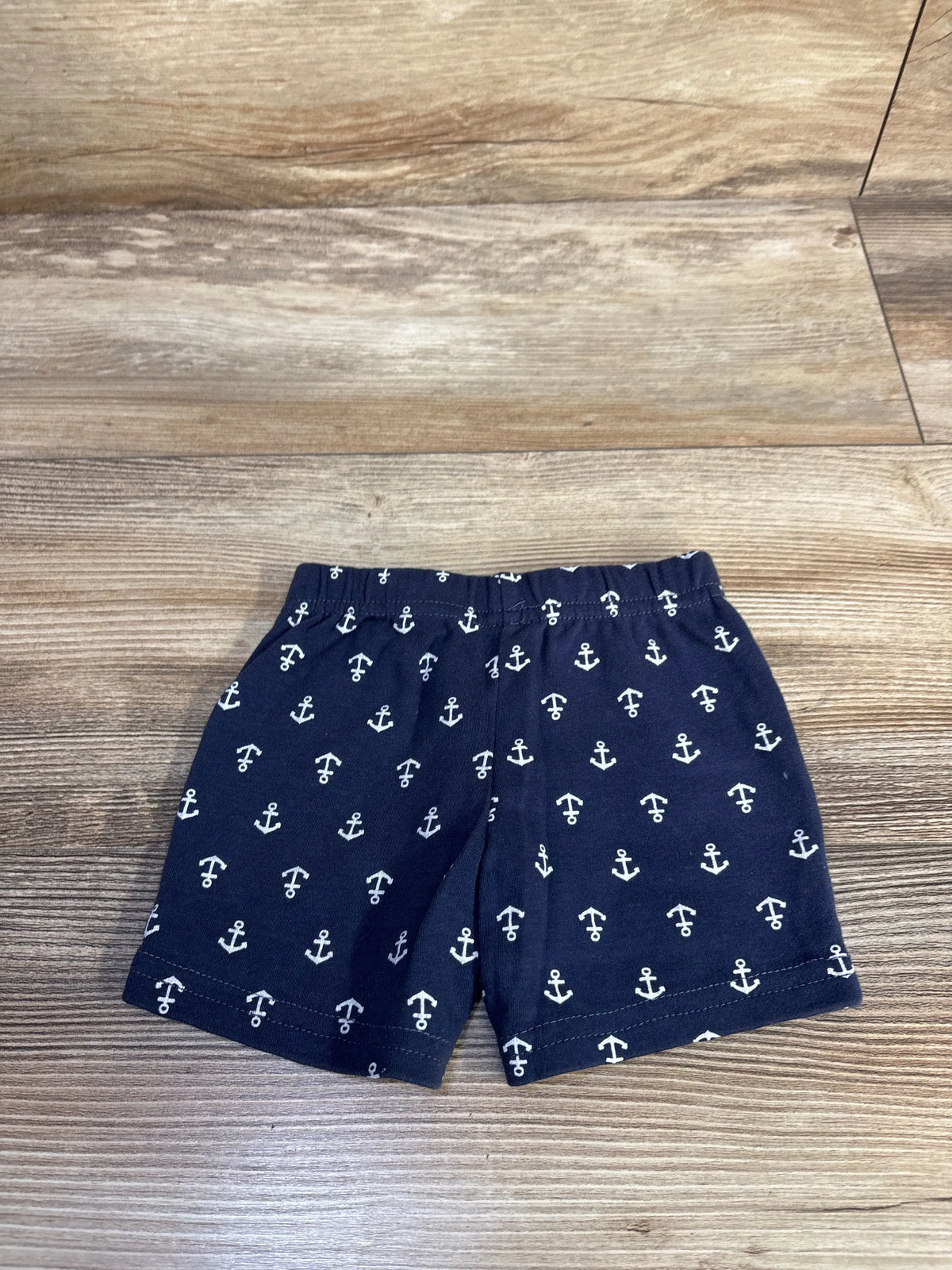 Front view of Hudson Baby anchor shorts in navy, size 0-3 months, showcasing white anchor pattern and elastic waistband