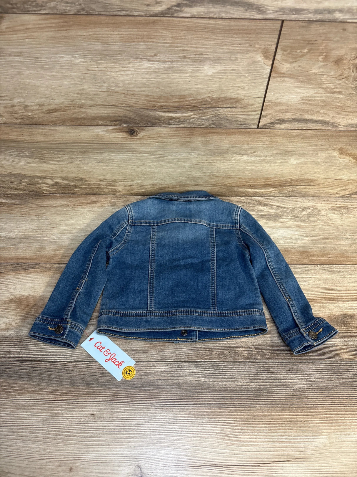 Cat & Jack kids denim jacket, blue, laid flat on wood floor, resale clothing for children