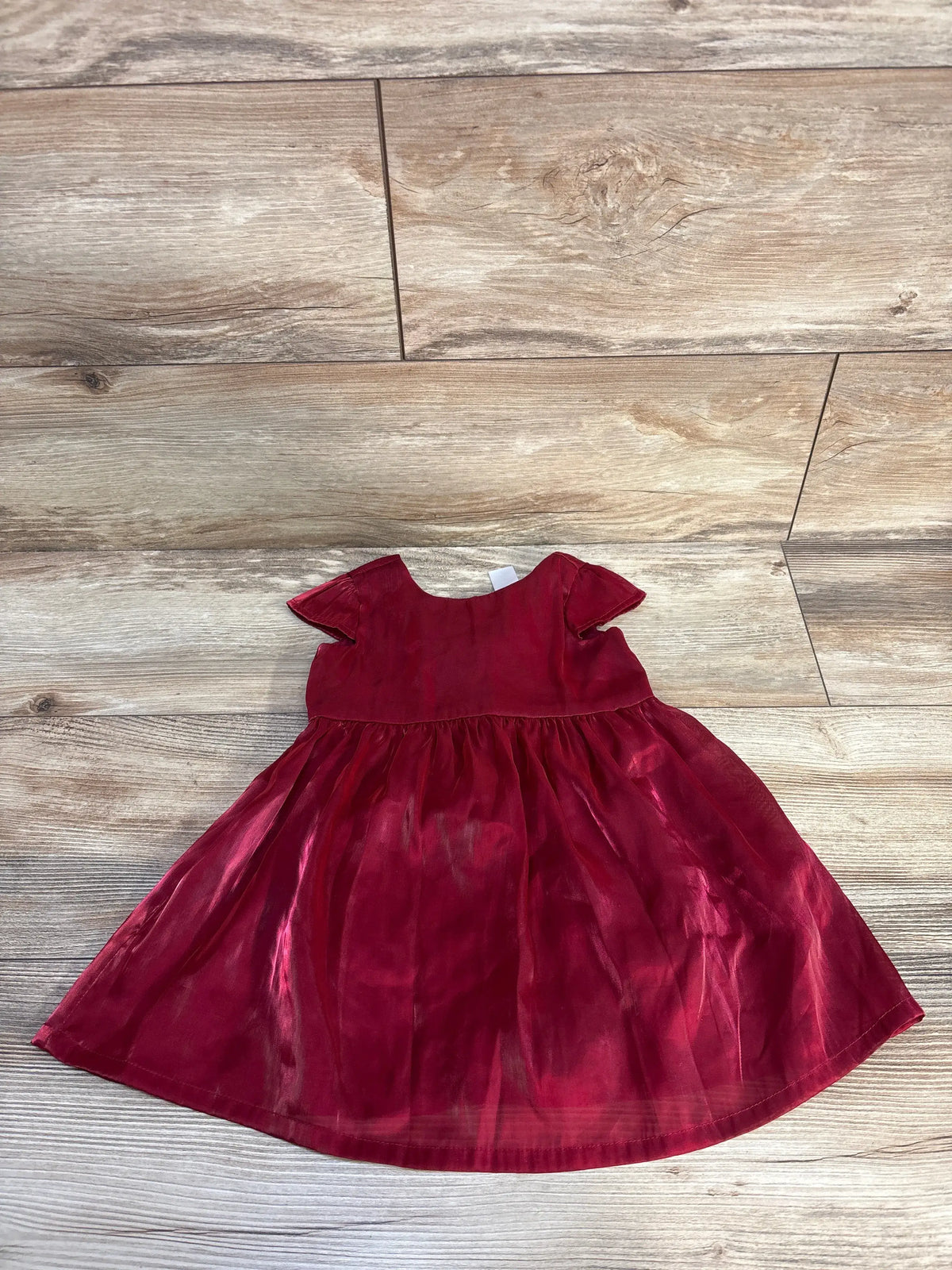 Red satin Just One You baby girl dress size 12m on a wooden background