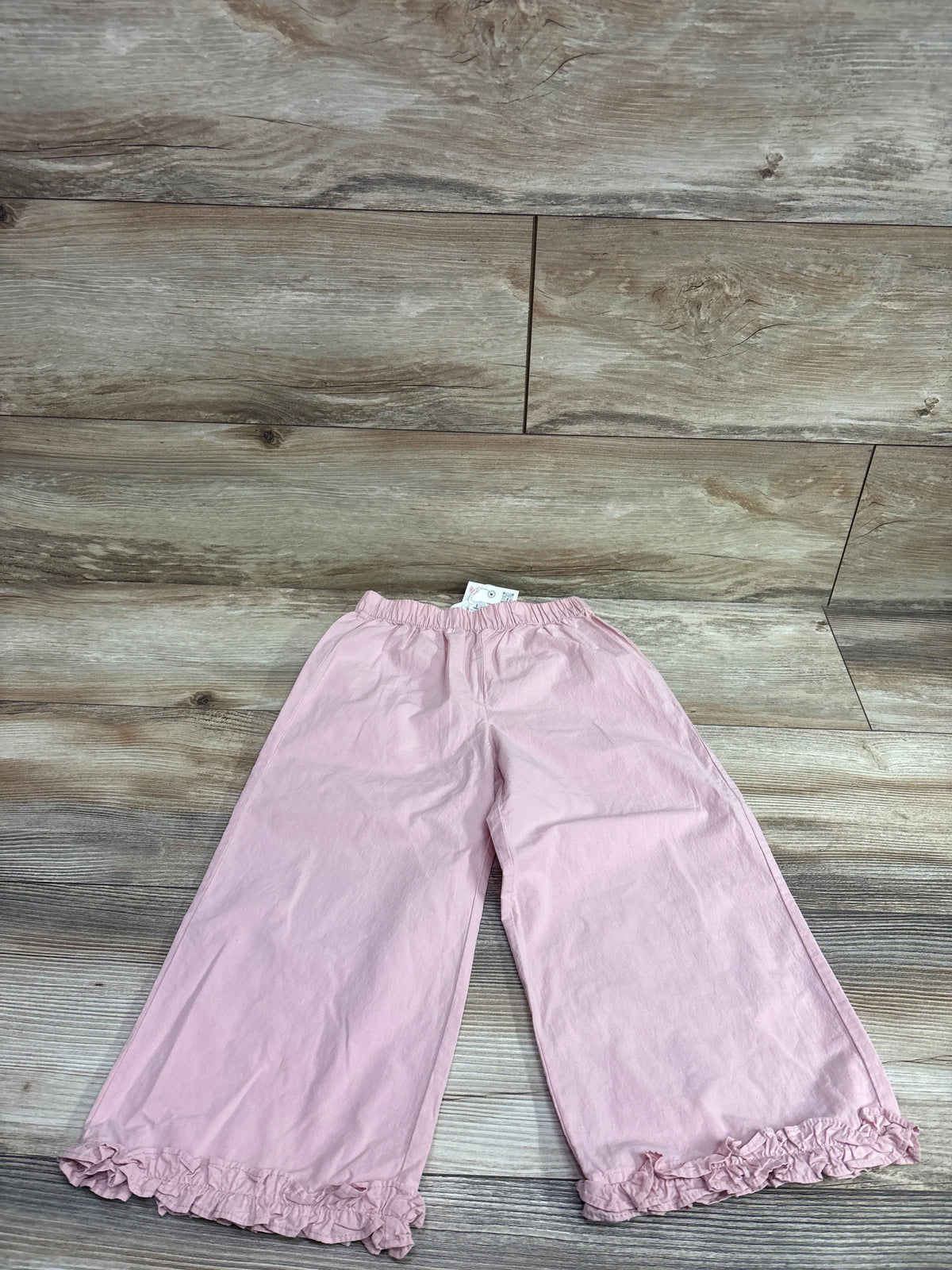 New Zara pink wide-leg ruffle trim pants for toddlers size 5T on a wood background
