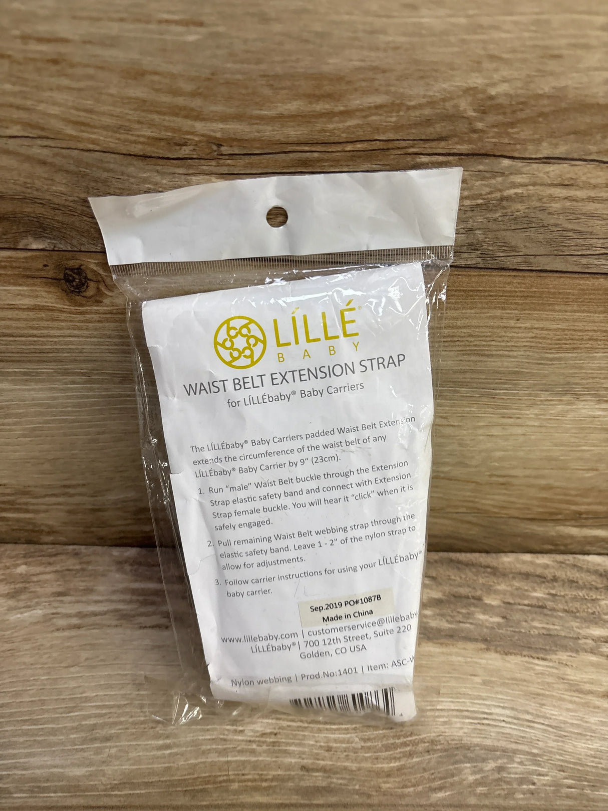 Lillebaby waist belt extension strap for baby carriers in sealed packaging on wood surface