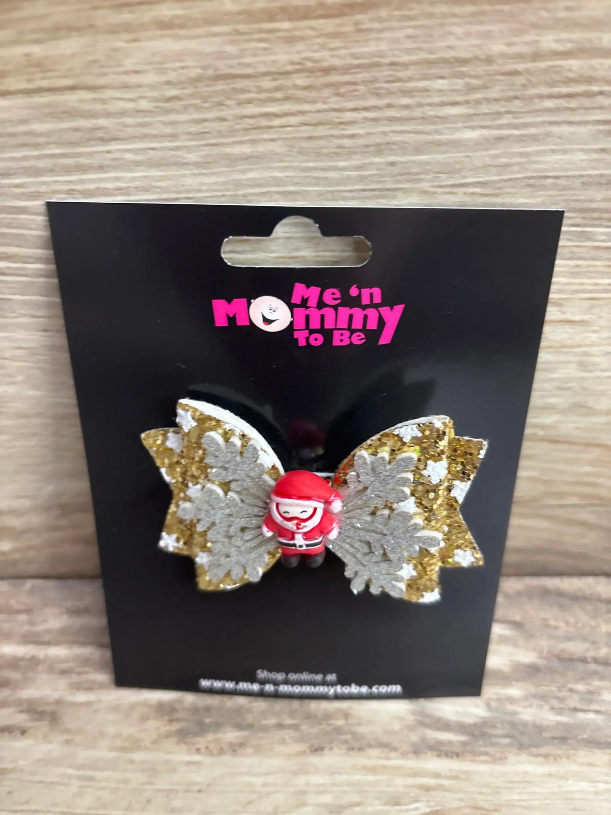 Santa-themed hair bow with gold glitter and snowflake wings for kids, festive holiday accessory