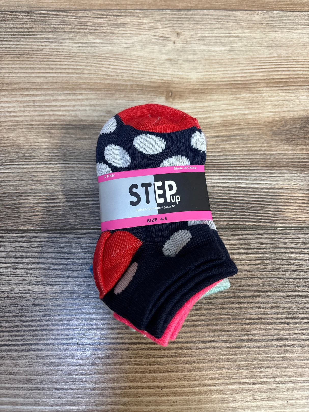 Kids polka dot socks pack size 4-6, navy blue with red accents, on wood surface