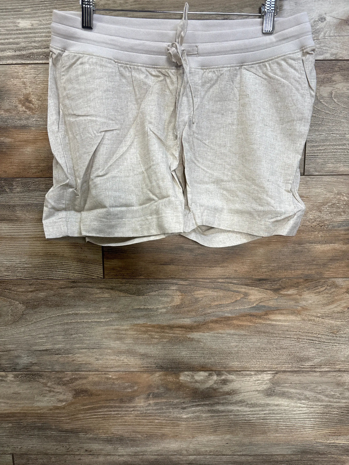 Front view of beige Gap maternity linen-blend shorts showcasing elastic under-belly waist, drawcords and slant pockets