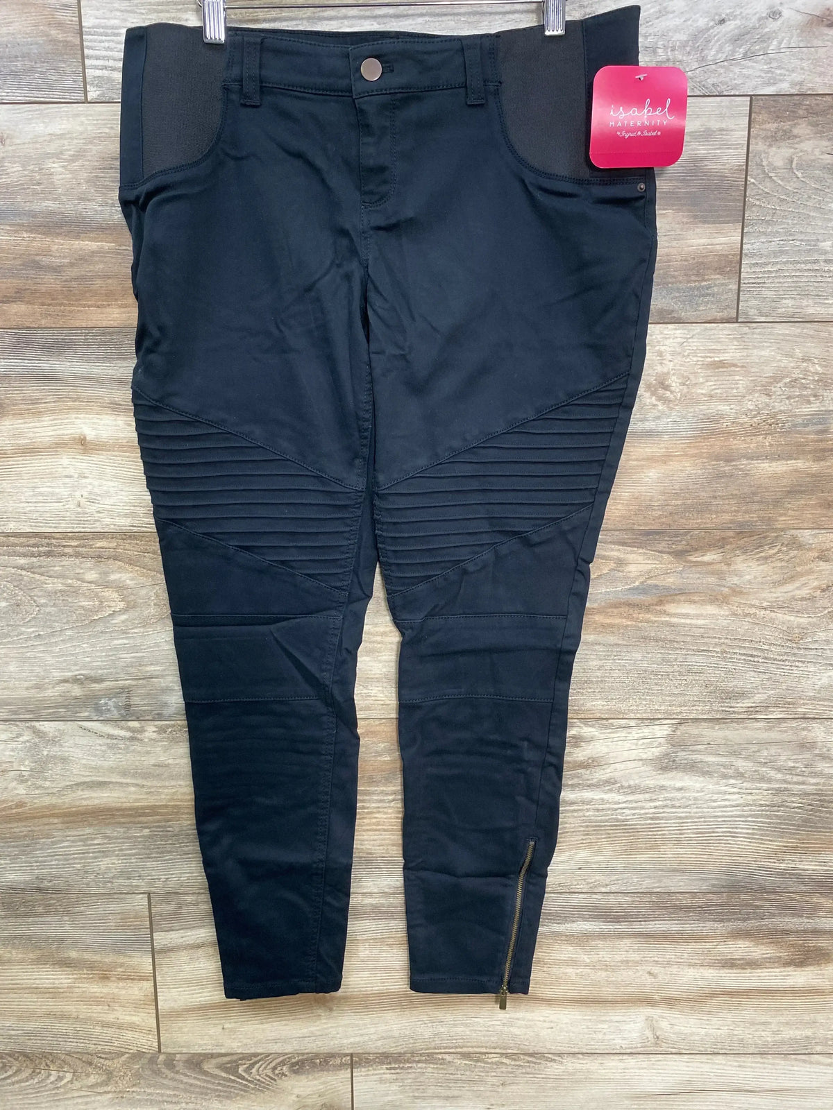 Black Isabel Maternity pants with ribbed knee detailing and ankle zipper on wooden floor