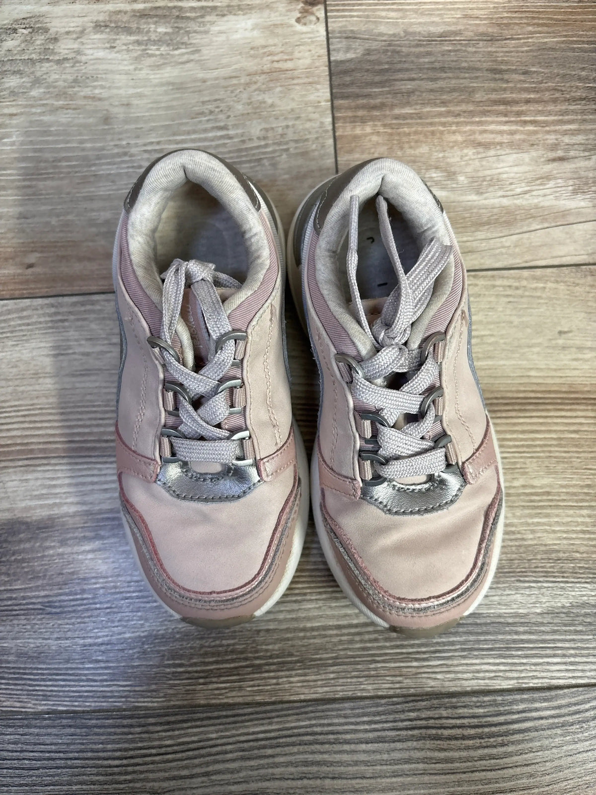 Top view of Mayoral Makeup Sneakers in pink size 11C showcasing functional lace closure on a wood look floor