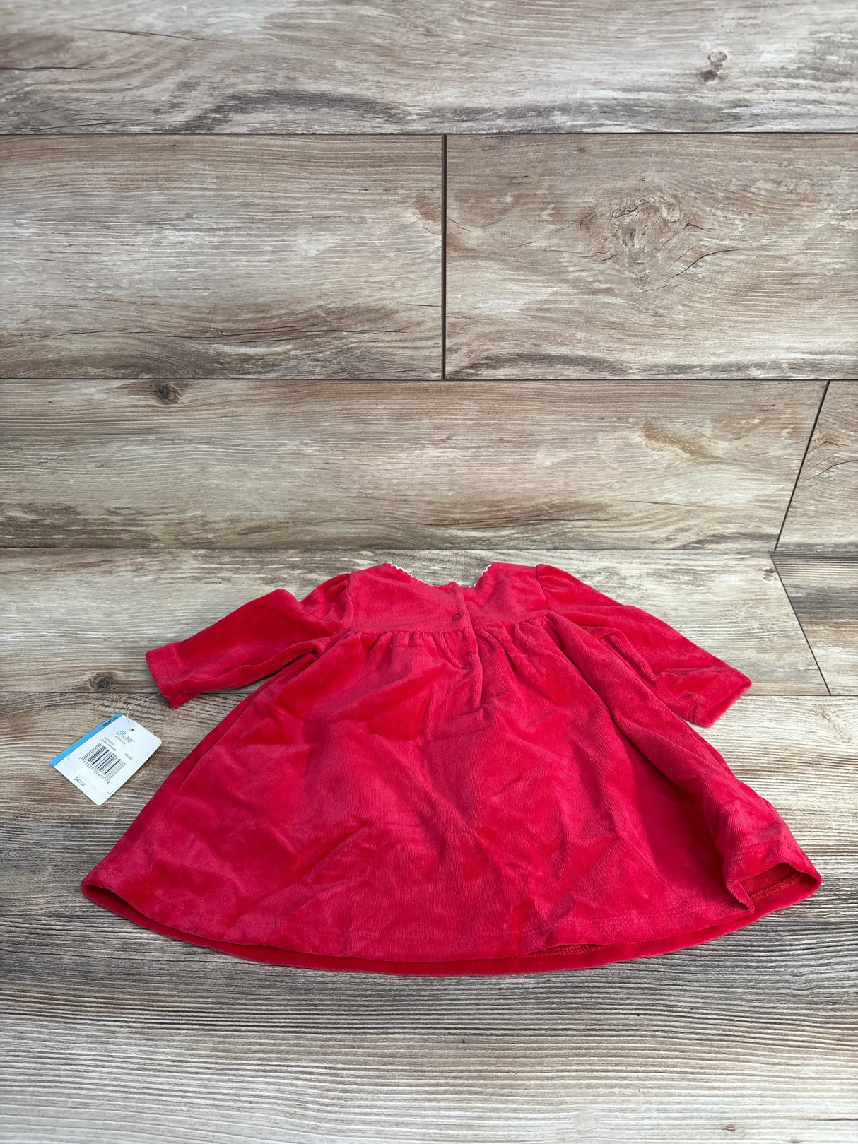 Red velvet long-sleeve baby dress with buttons on wooden floor, kids resale apparel