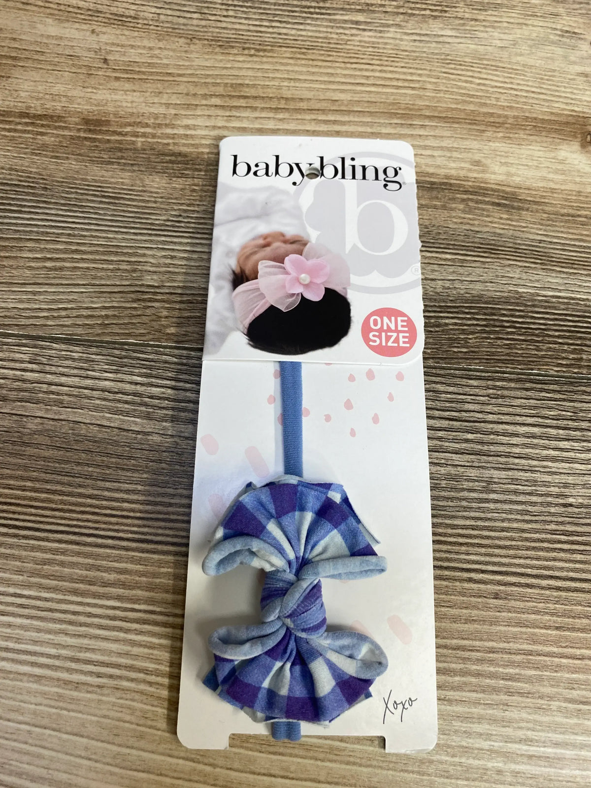 Baby Bling blue checkered baby headband on retail card, one size, on wood background