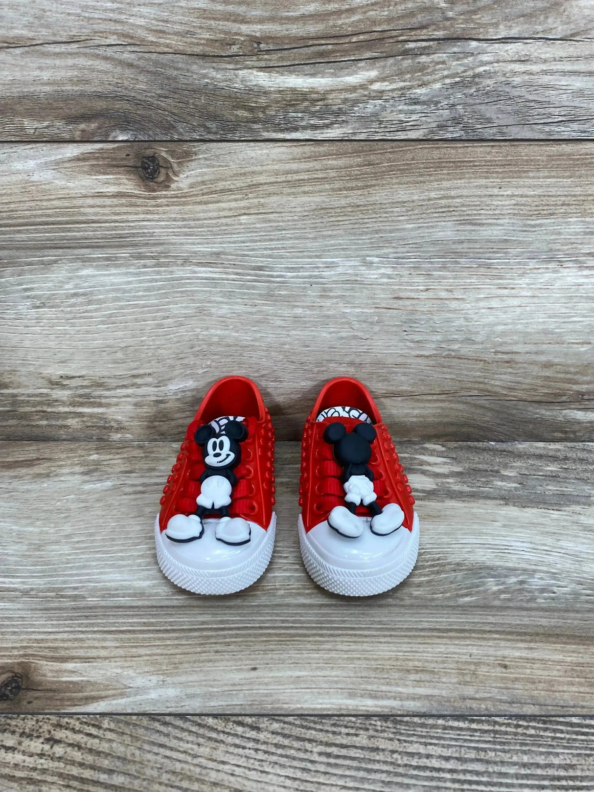 Side view of Mini Melissa Polibolha x Disney red toddler sneaker with bubble-texture upper and Mickey accent