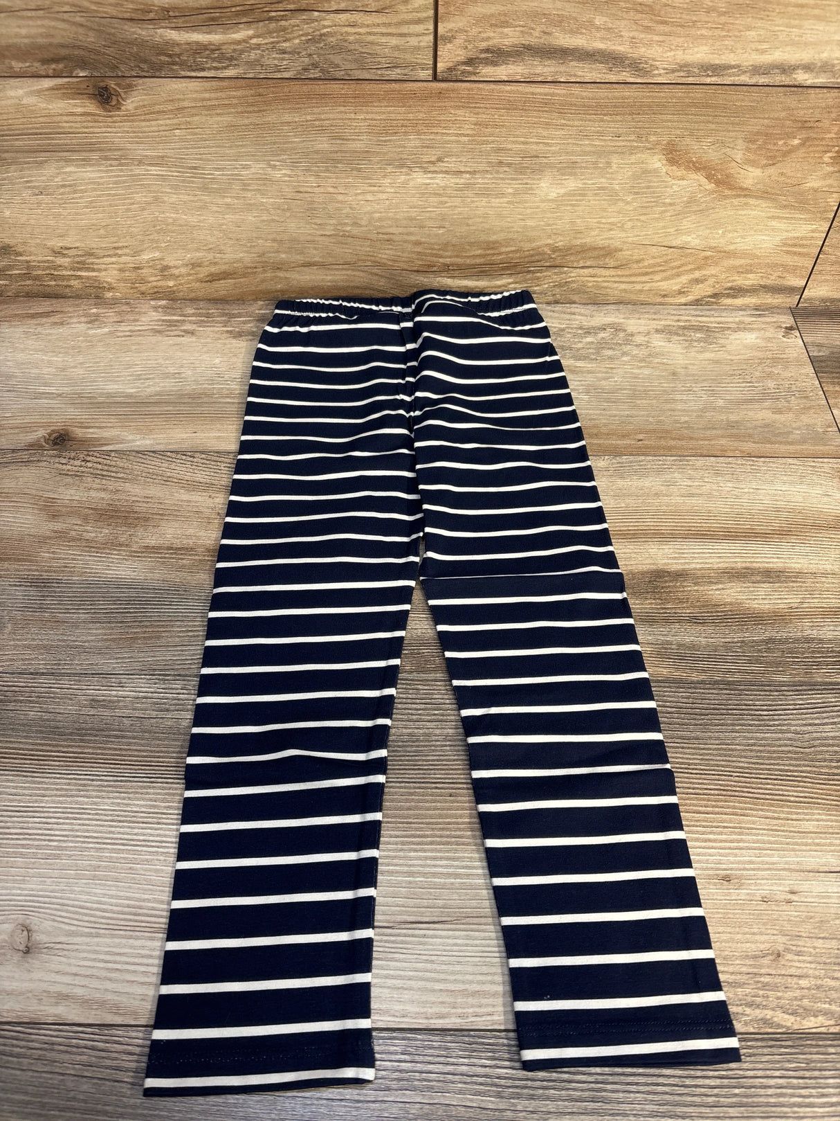 Navy and white striped kids leggings on wooden floor