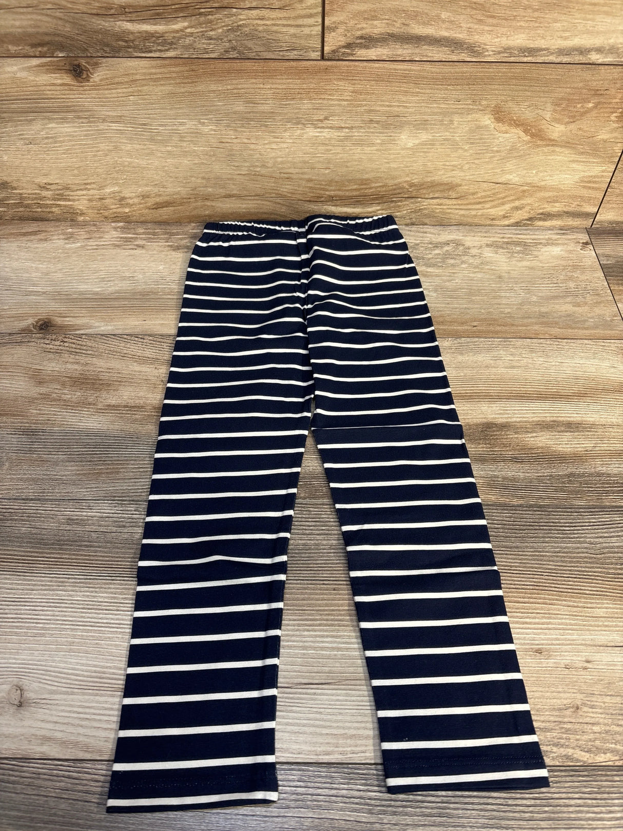 Navy and white striped kids leggings on wooden floor