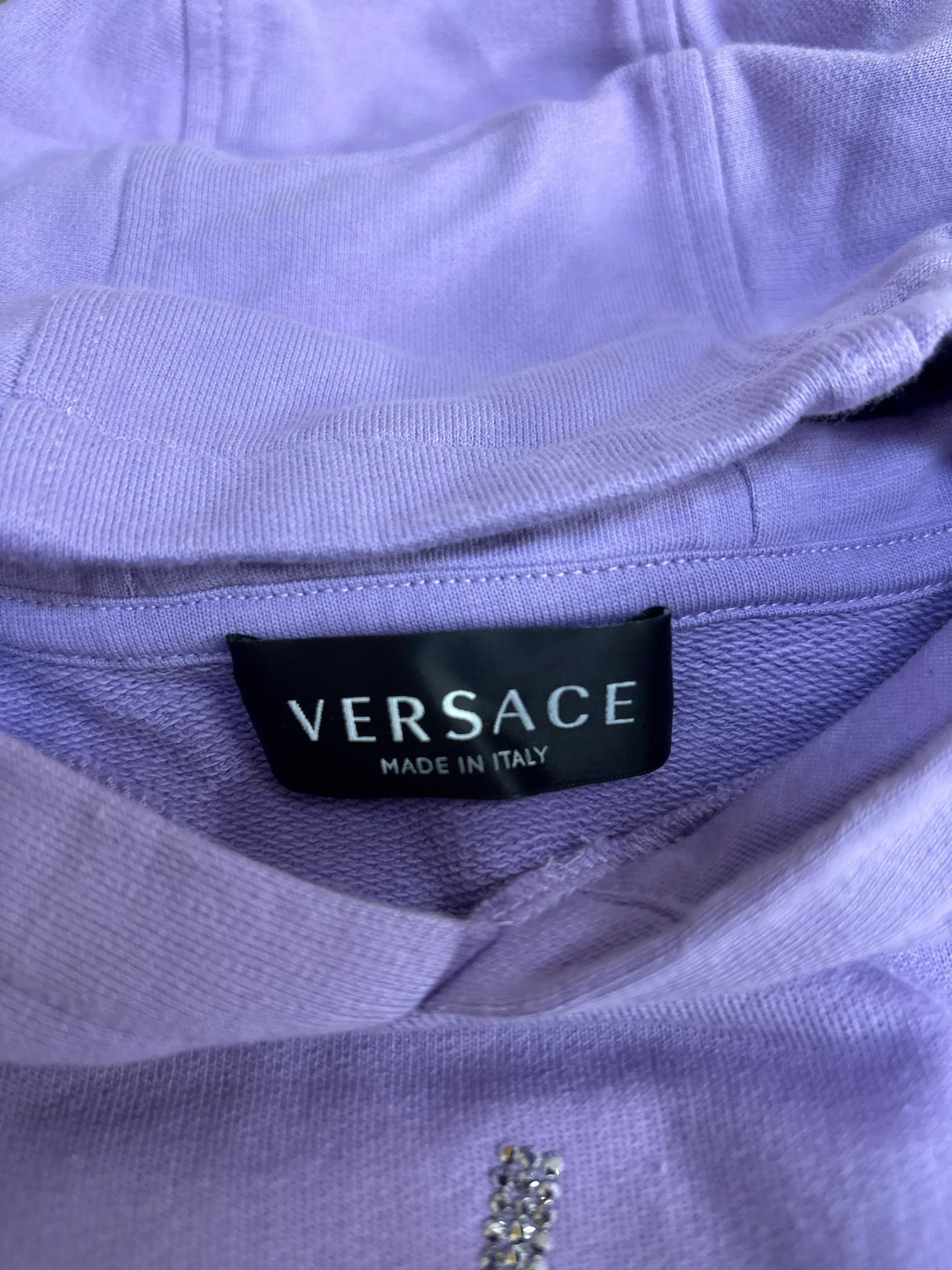 Versace Made in Italy label on light purple fabric sweatshirt