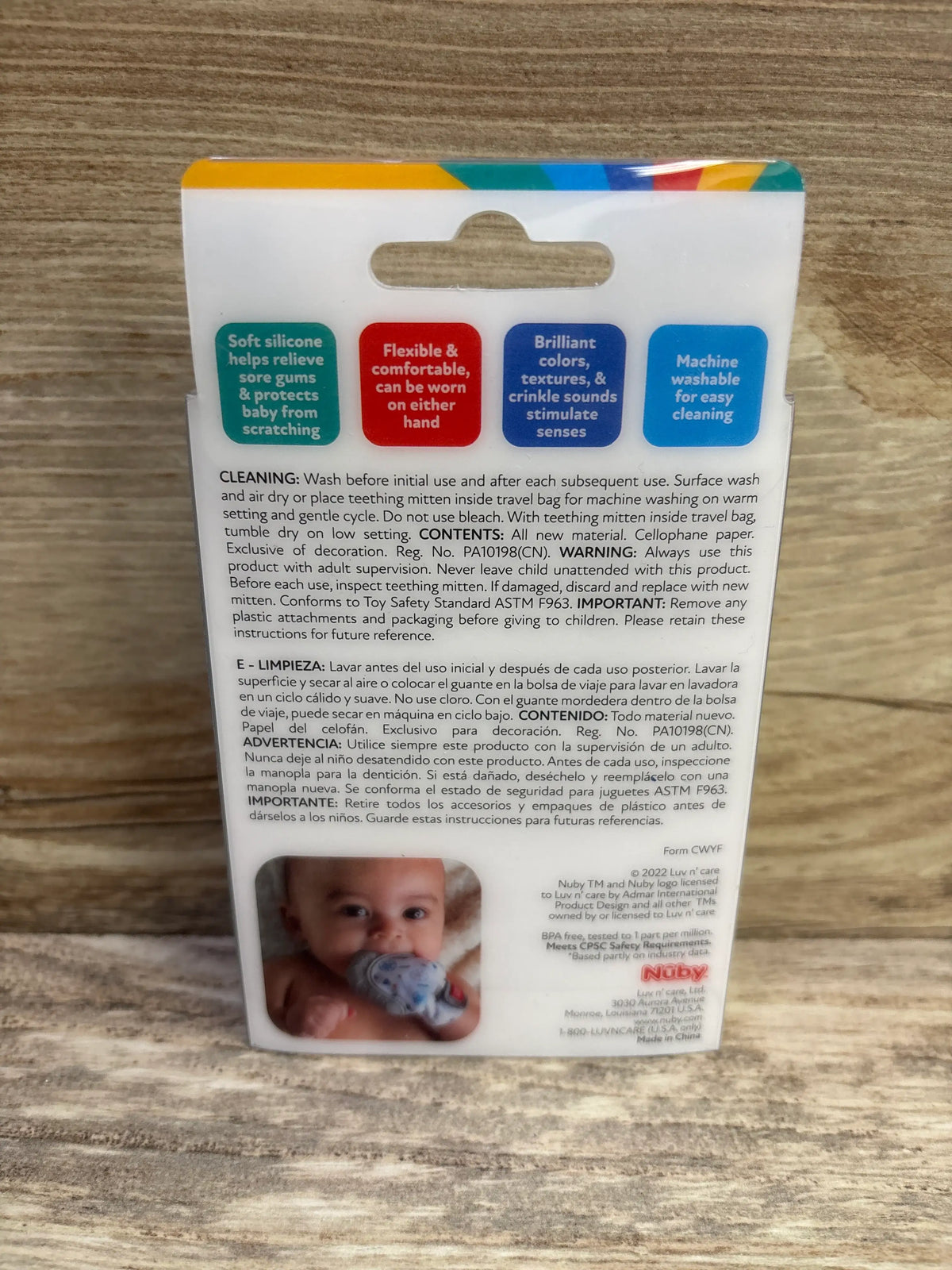 Back of Nuby Happy Hands Penguin Teething Mitten package showing soft silicone, two-hand wear, and machine-washable care